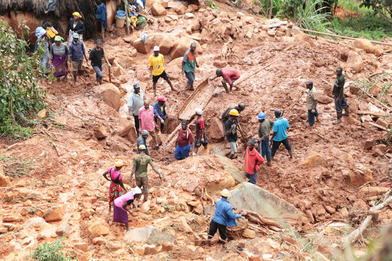 In Chimanimani, Zimbabwe, a family digs for their son in the mud after Cyclone Idai hit.